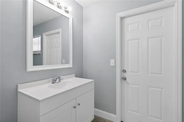 a bathroom with a sink a vanity and a mirror