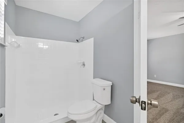 a white toilet sitting next to a bathroom sink