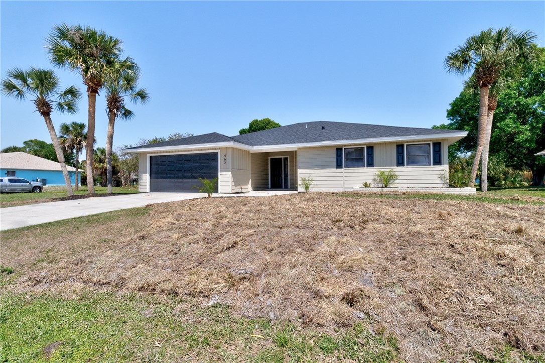 462 Watercrest Street Sebastian, FL 32958 - Photo 2 of 36 a front view of a house with garden
