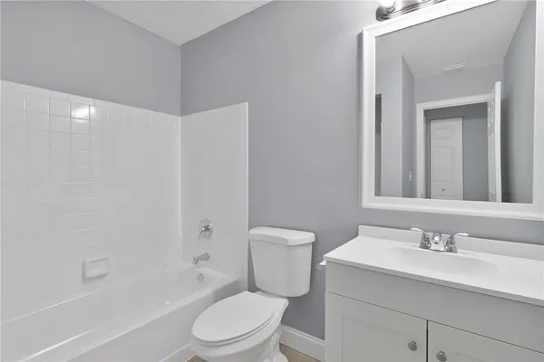 a bathroom with a sink toilet vanity and shower
