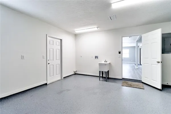 a view of a livingroom with a chair and a cabinet