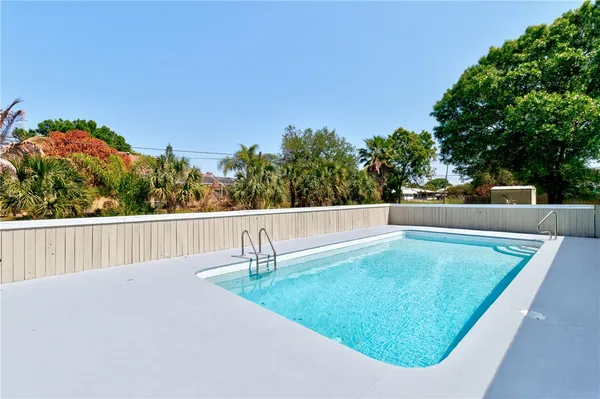 a view of a swimming pool with a patio