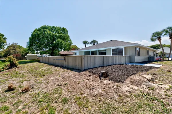 a backyard of a house with wooden fence