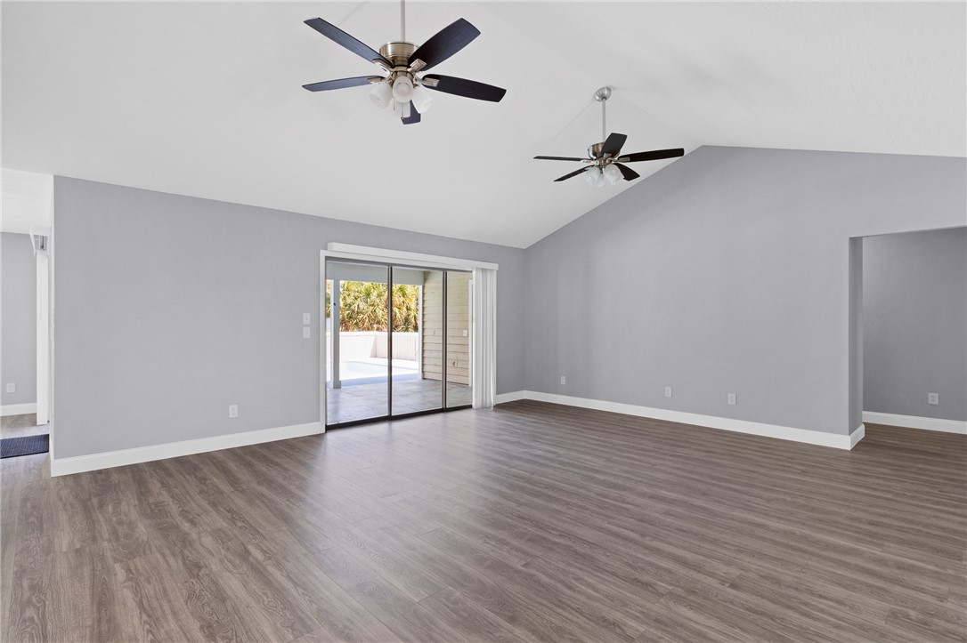 462 Watercrest Street Sebastian, FL 32958 - Photo 8 of 36 an empty room with wooden floor ceiling fan and windows