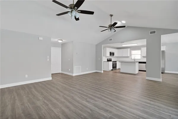 a view of a kitchen with a dishwasher kitchen stove and cabinets
