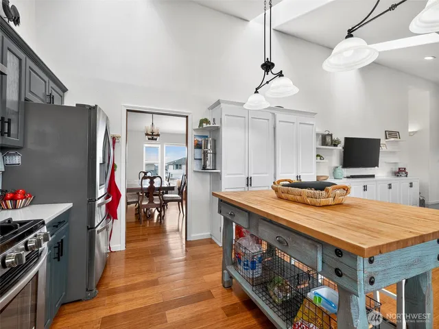 a kitchen with stainless steel appliances granite countertop a stove and a refrigerator