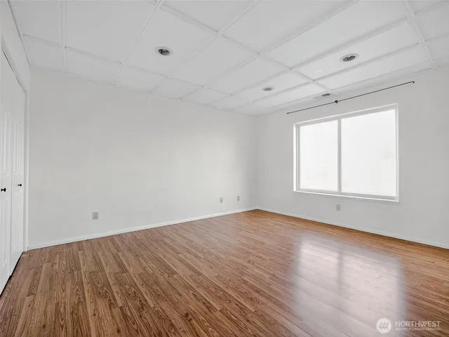 wooden floor in an empty room with a window