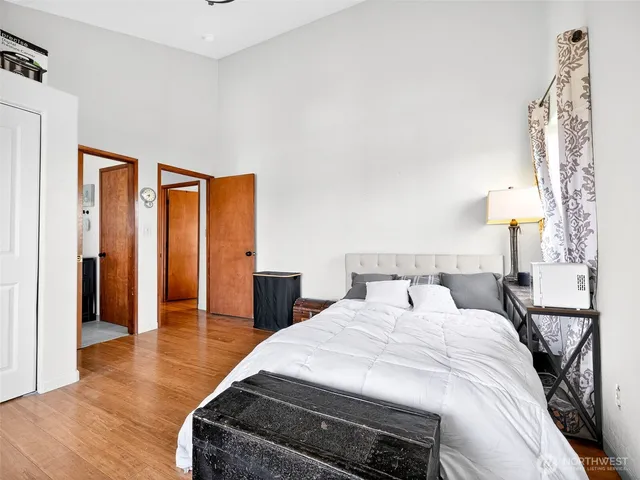 a bedroom with a bed and a lamp