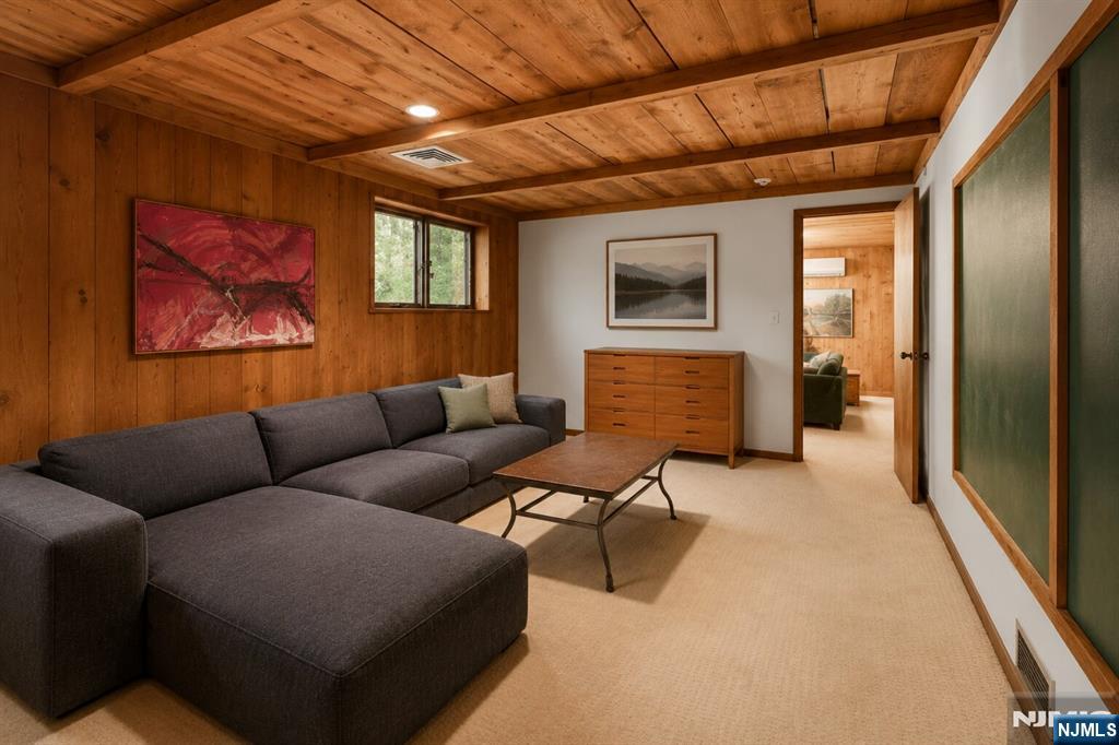 34 Cambridge Way Alpine, NJ 07620 - Photo 32 of 48 a living room with furniture and a flat screen tv