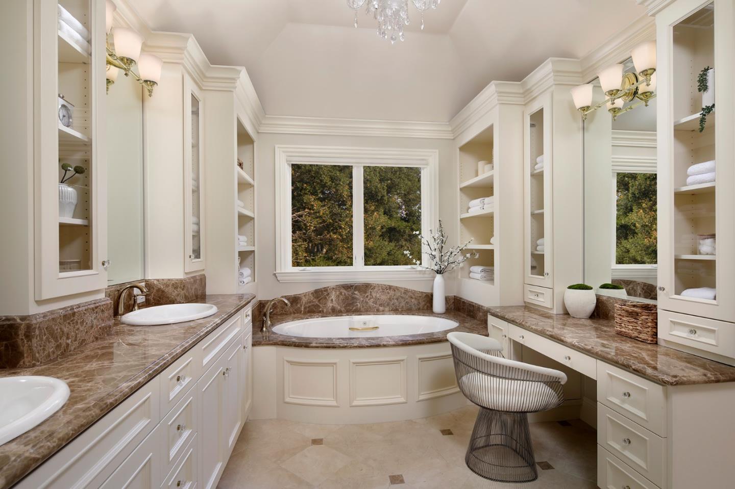 89 Almendral Avenue Atherton, CA 94027 - Photo 16 of 26 a spacious bathroom with a granite countertop sink and a large mirror
