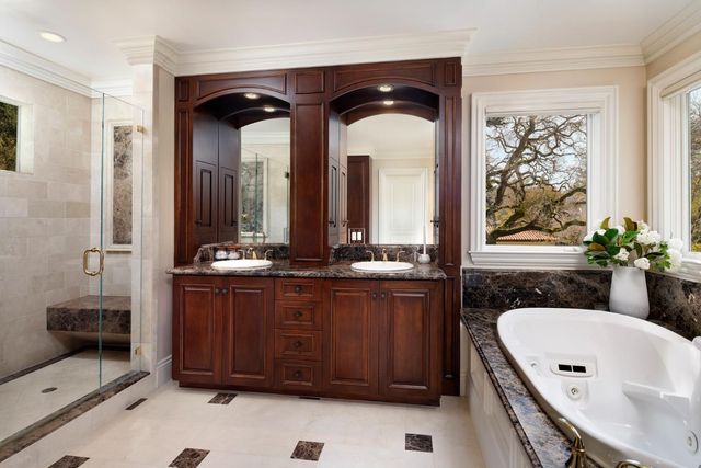 a bathroom with a double vanity sink and a bathtub