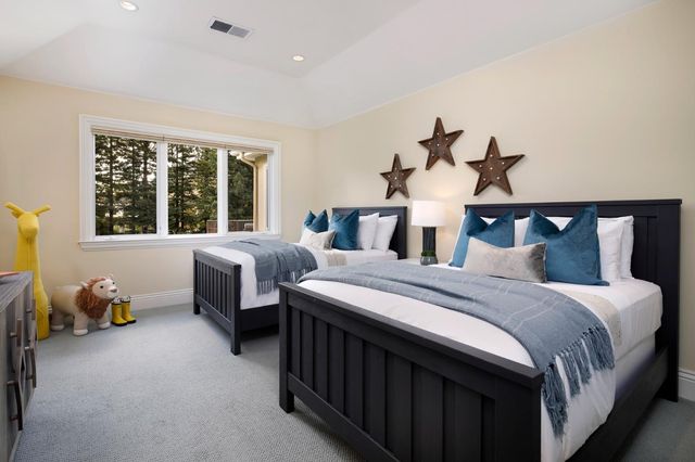 a bedroom with two beds and a window