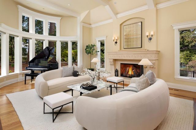 a living room with furniture a fireplace and windows