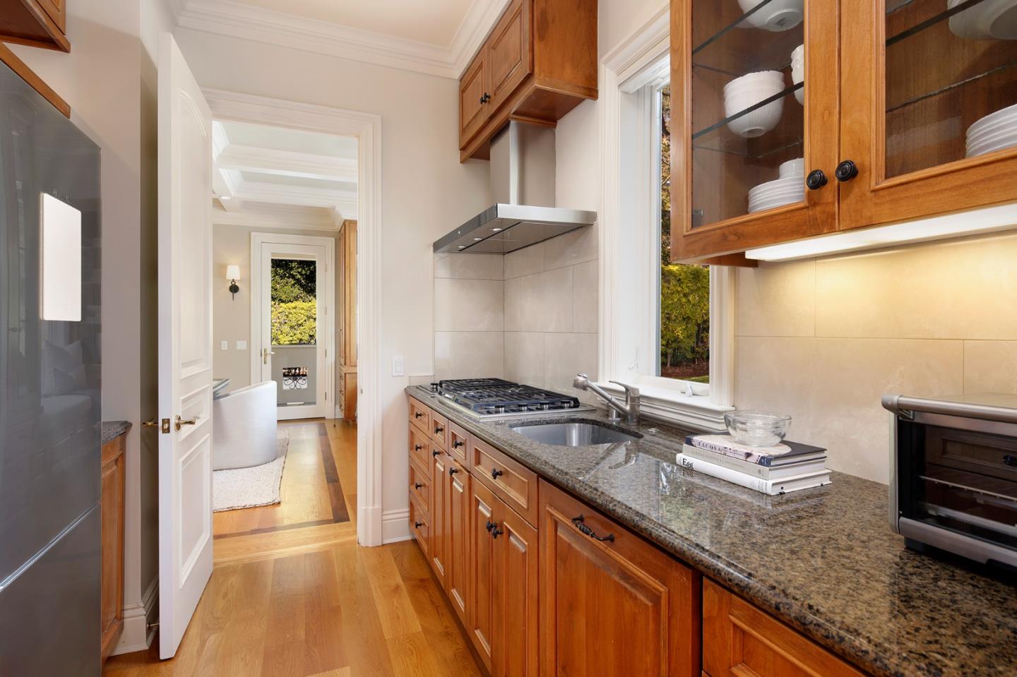 89 Almendral Avenue Atherton, CA 94027 - Photo 6 of 26 a kitchen with stainless steel appliances granite countertop a stove and a sink