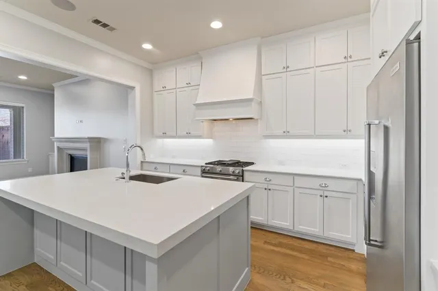 a kitchen with a stove a sink and a refrigerator