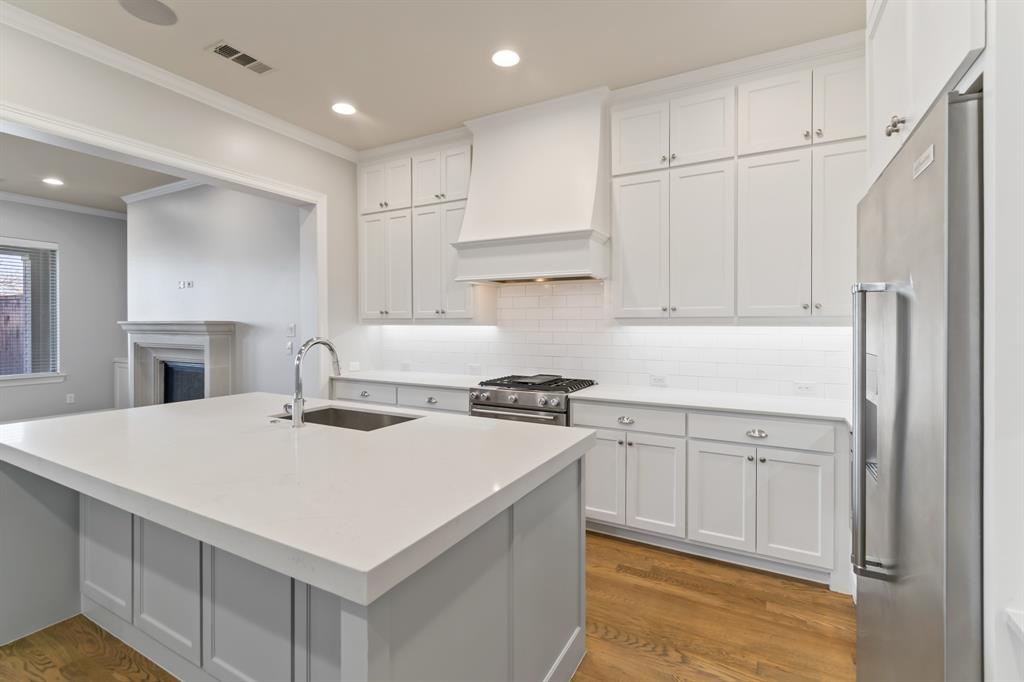 6531 Roper Street Dallas, TX 75209 - Photo 11 of 40 a kitchen with a stove a sink and a refrigerator