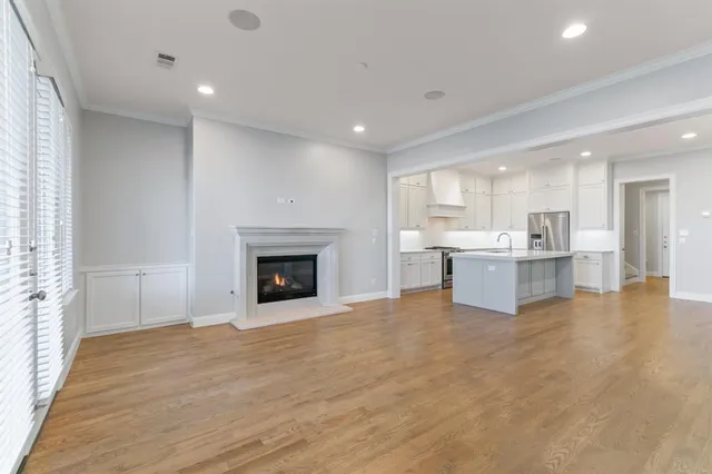 a view of a kitchen with a sink and a fireplace
