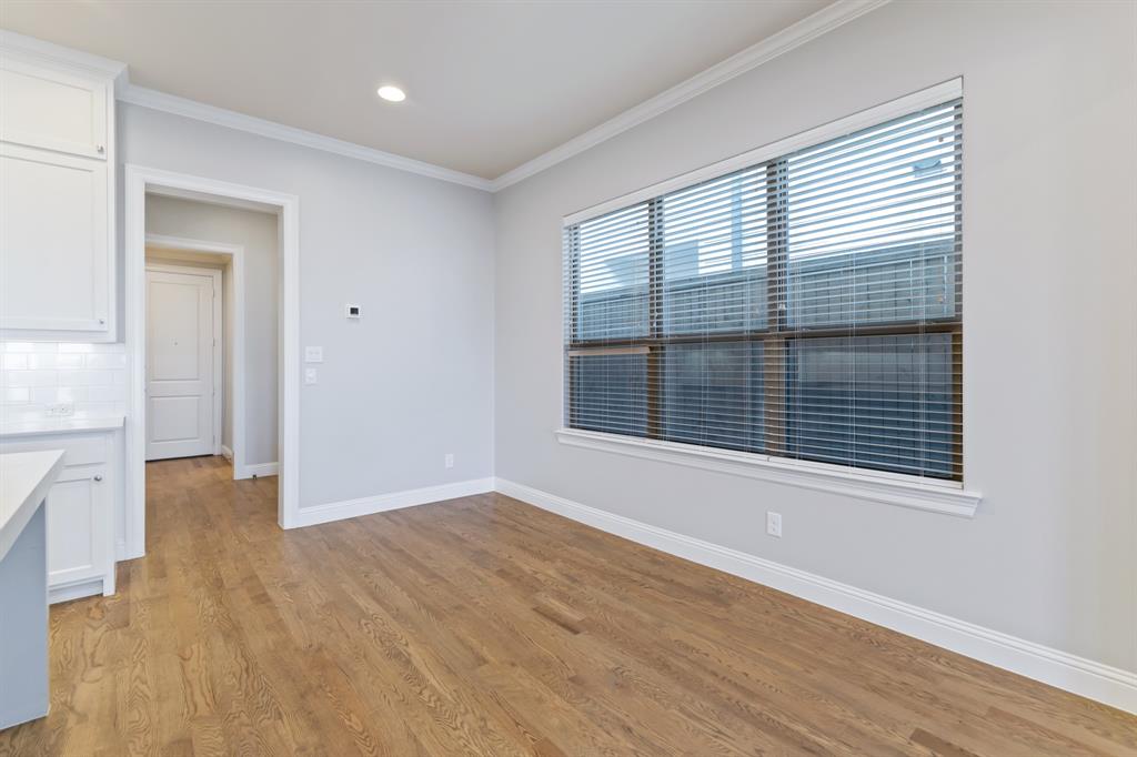 6531 Roper Street Dallas, TX 75209 - Photo 13 of 40 a view of an empty room with wooden floor and a window