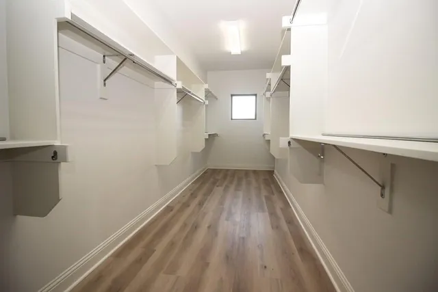 a view of a room with wooden floor and white walls