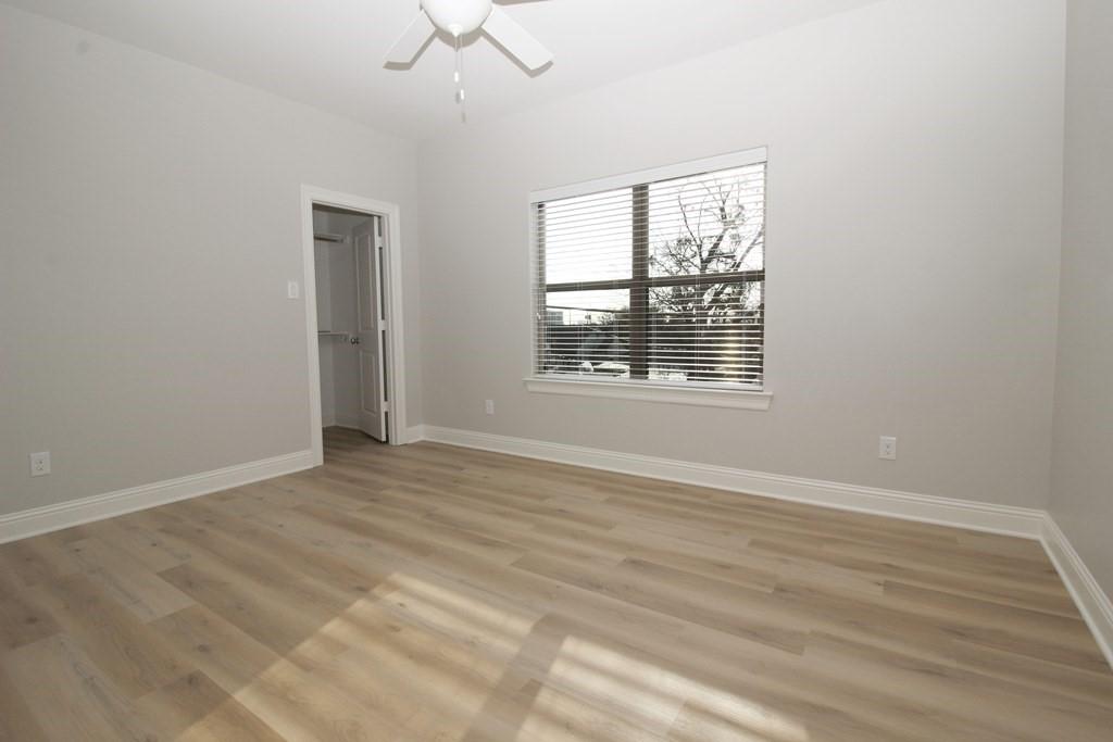 6531 Roper Street Dallas, TX 75209 - Photo 30 of 40 a view of an empty room with wooden floor and a window