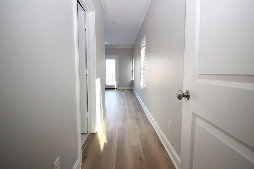 6531 Roper Street Dallas, TX 75209 - Photo 35 of 40 a view of a hallway with wooden floor and staircase