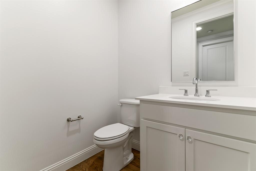 6531 Roper Street Dallas, TX 75209 - Photo 36 of 40 a bathroom with a sink a toilet and mirror