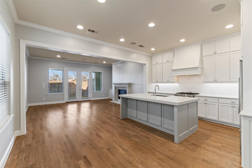 6531 Roper Street Dallas, TX 75209 - Photo 6 of 40 a kitchen with a sink microwave and cabinets