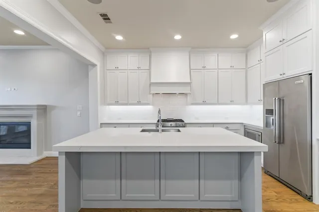 a kitchen with kitchen island cabinets and refrigerator