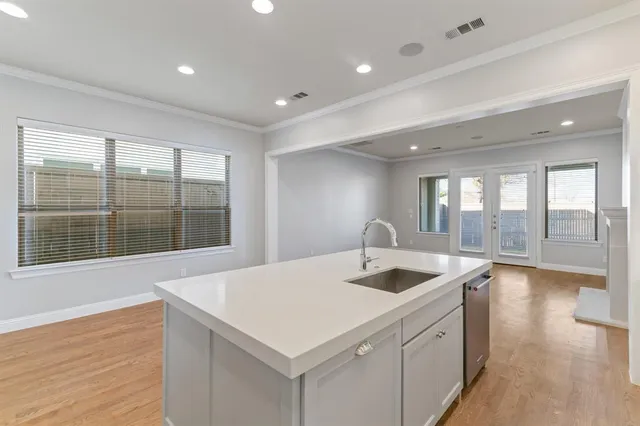 a kitchen with a sink and large window