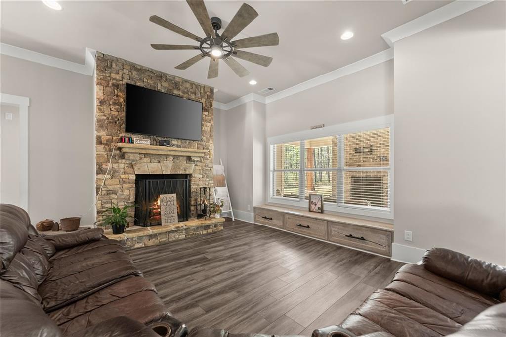 970 GA Highway 211 Winder, GA 30680 - Photo 12 of 60 a living room with furniture a flat screen tv and a fireplace