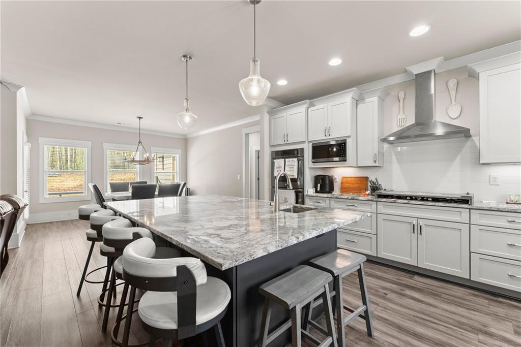 970 GA Highway 211 Winder, GA 30680 - Photo 15 of 60 a kitchen with stainless steel appliances granite countertop a stove a sink a stove a dining table and chairs