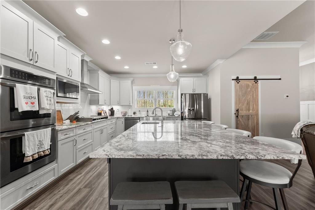 970 GA Highway 211 Winder, GA 30680 - Photo 17 of 60 a kitchen with stainless steel appliances granite countertop a stove refrigerator and cabinets