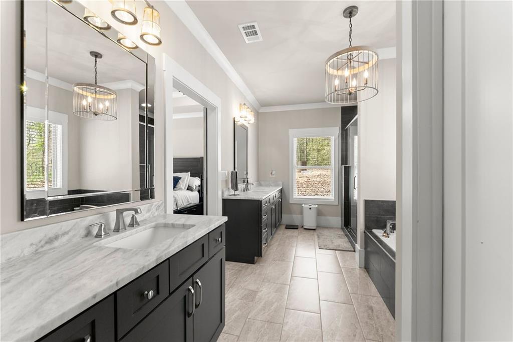 970 GA Highway 211 Winder, GA 30680 - Photo 25 of 60 a spacious bathroom with a granite countertop sink mirror and a bathtub