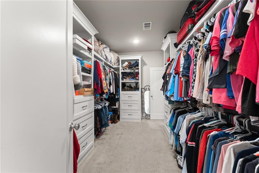 970 GA Highway 211 Winder, GA 30680 - Photo 29 of 60 a view of walk in closet with clothes