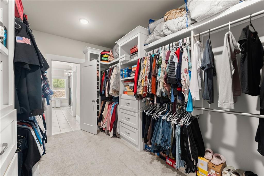 970 GA Highway 211 Winder, GA 30680 - Photo 30 of 60 a view of walk in closet with clothes and shoes