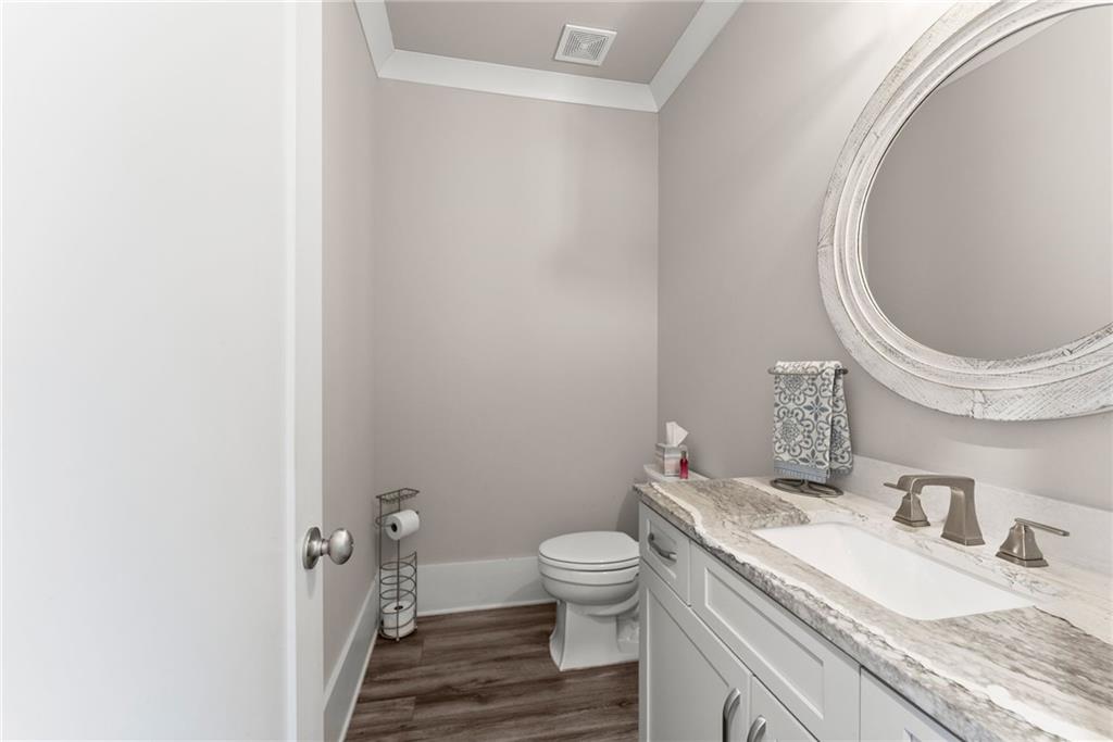 970 GA Highway 211 Winder, GA 30680 - Photo 32 of 60 a bathroom with a granite countertop toilet and a sink