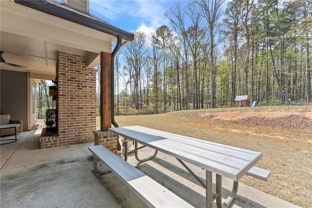 970 GA Highway 211 Winder, GA 30680 - Photo 50 of 60 a view of a patio with a table and chairs and potted plants
