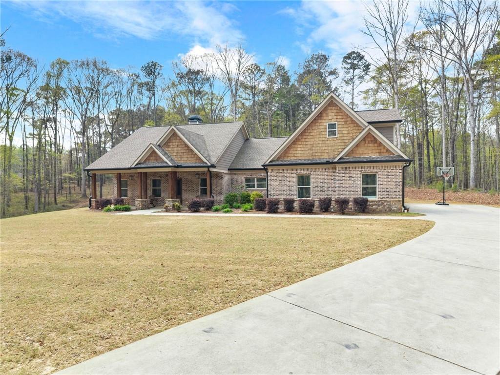 970 GA Highway 211 Winder, GA 30680 - Photo 5 of 60 a front view of a house with a garden
