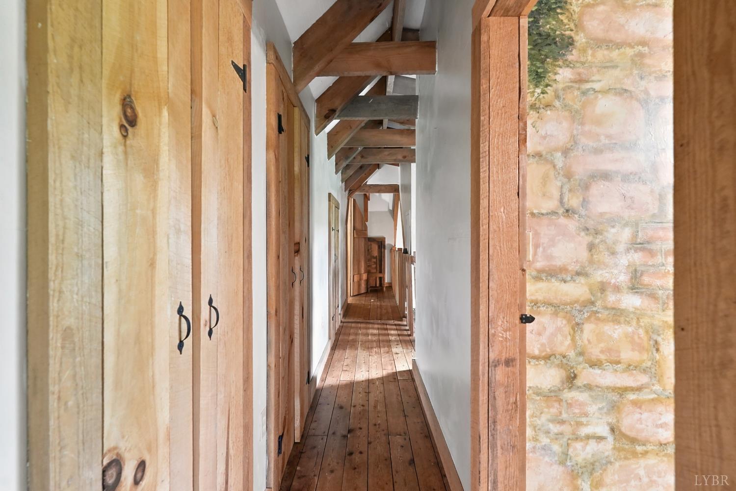 Undisclosed Address Spout Spring, VA 24593 - Photo 48 of 96 a view of a hallway with wooden floor and a bathroom