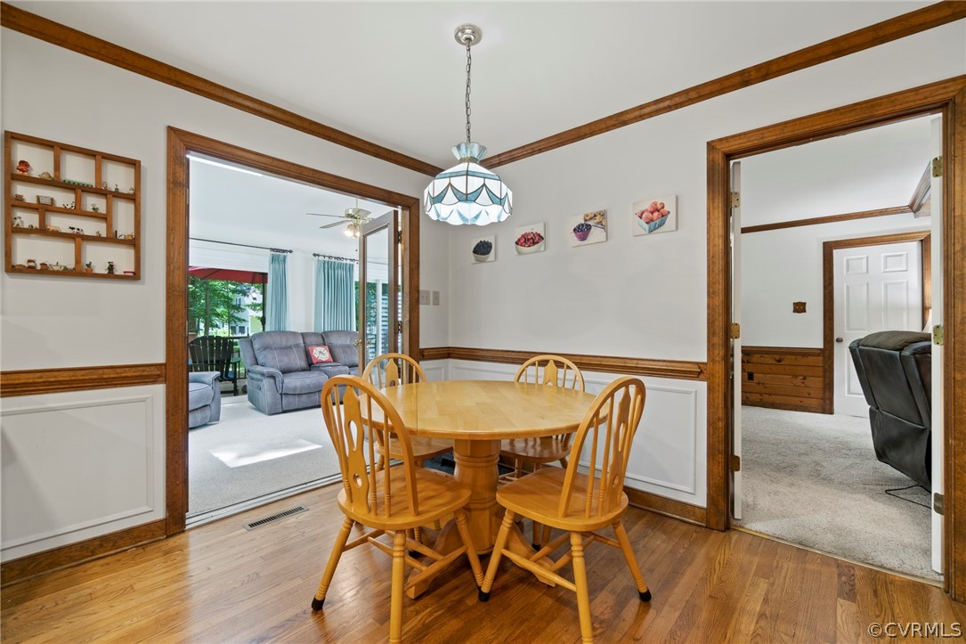 13903 Beechwood Point Road Midlothian, VA 23112 - Photo 11 of 33 a dining room with furniture a chandelier and wooden floor