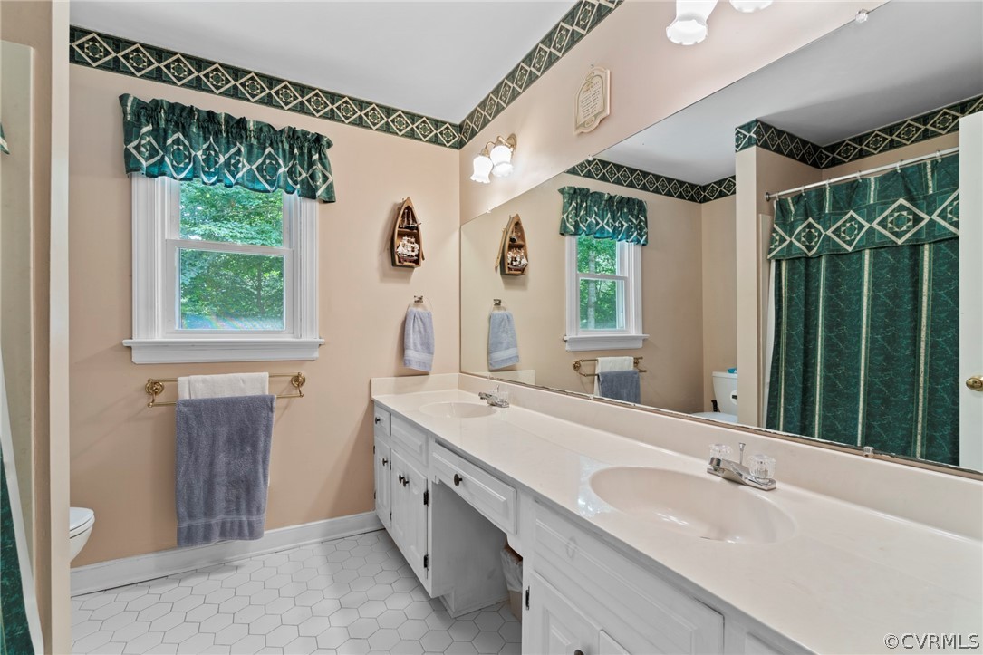 13903 Beechwood Point Road Midlothian, VA 23112 - Photo 20 of 33 a bathroom with a granite countertop sink mirror and a large window