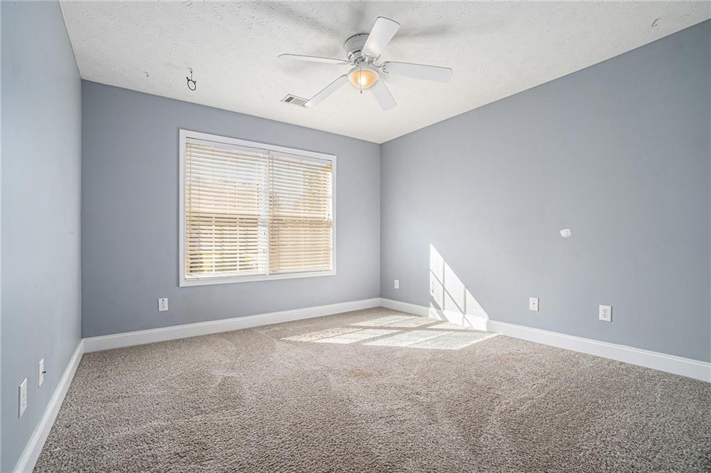 21 Cartee Lane Dallas, GA 30157 - Photo 17 of 29 a view of a big room with windows and chandelier fan