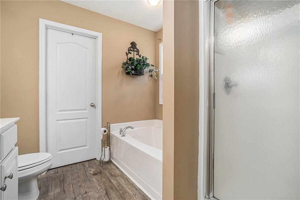 21 Cartee Lane Dallas, GA 30157 - Photo 21 of 29 a bathroom with a bathtub and a toilet