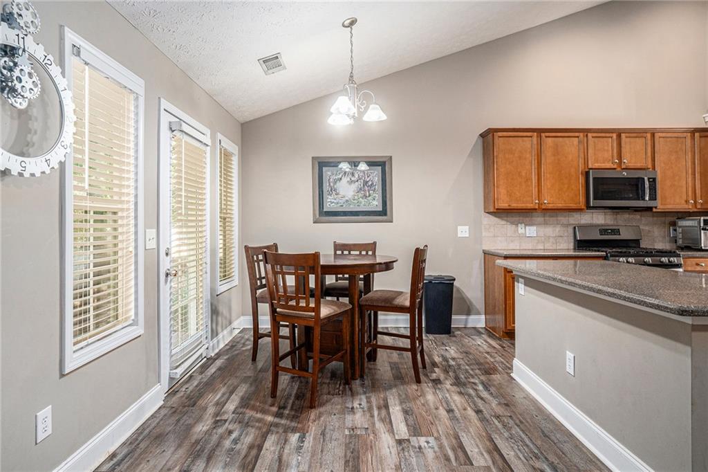 21 Cartee Lane Dallas, GA 30157 - Photo 7 of 29 a view of a dining room with furniture and wooden floor