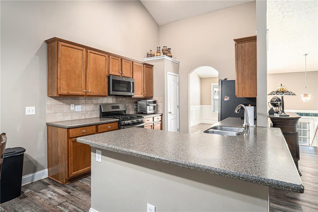 21 Cartee Lane Dallas, GA 30157 - Photo 8 of 29 a kitchen with stainless steel appliances granite countertop a sink a stove counter space and cabinets