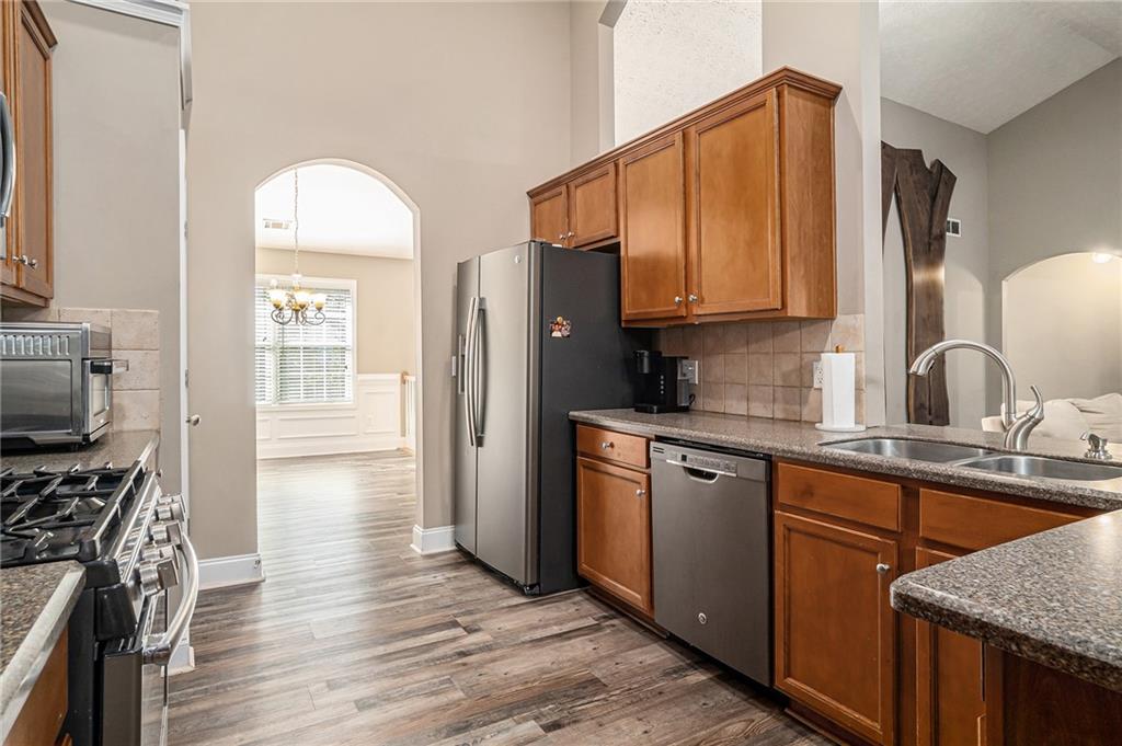 21 Cartee Lane Dallas, GA 30157 - Photo 9 of 29 a kitchen with stainless steel appliances granite countertop a refrigerator stove and sink