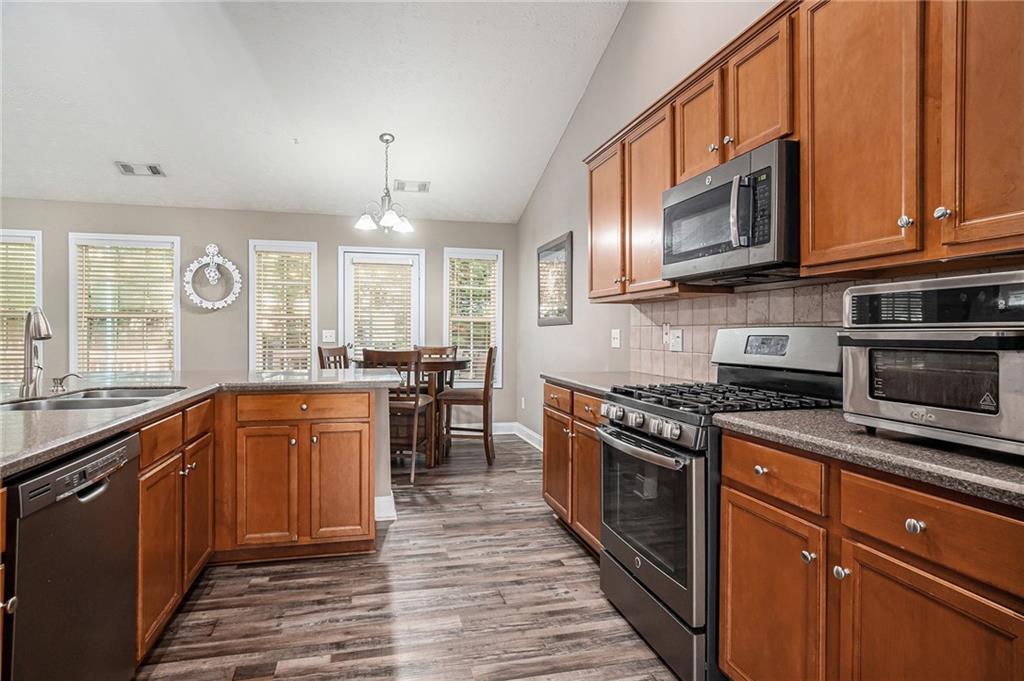 21 Cartee Lane Dallas, GA 30157 - Photo 10 of 29 a kitchen with stainless steel appliances granite countertop a stove a sink and a microwave