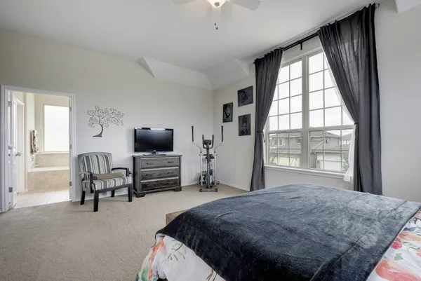 a bedroom with a bed and a television