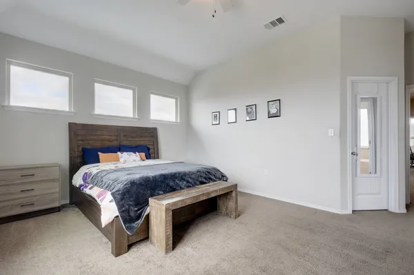 a bed sitting in a bedroom and closet