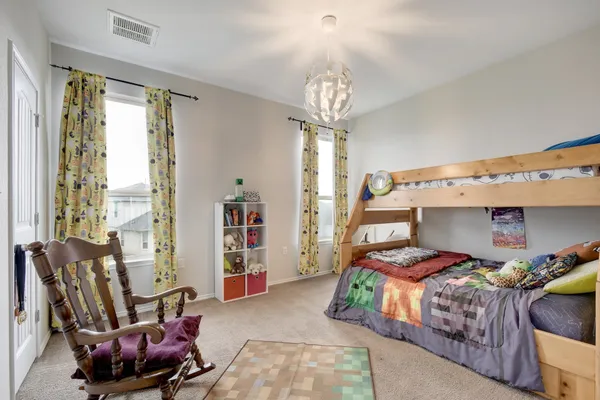 a bedroom with furniture and a chandelier